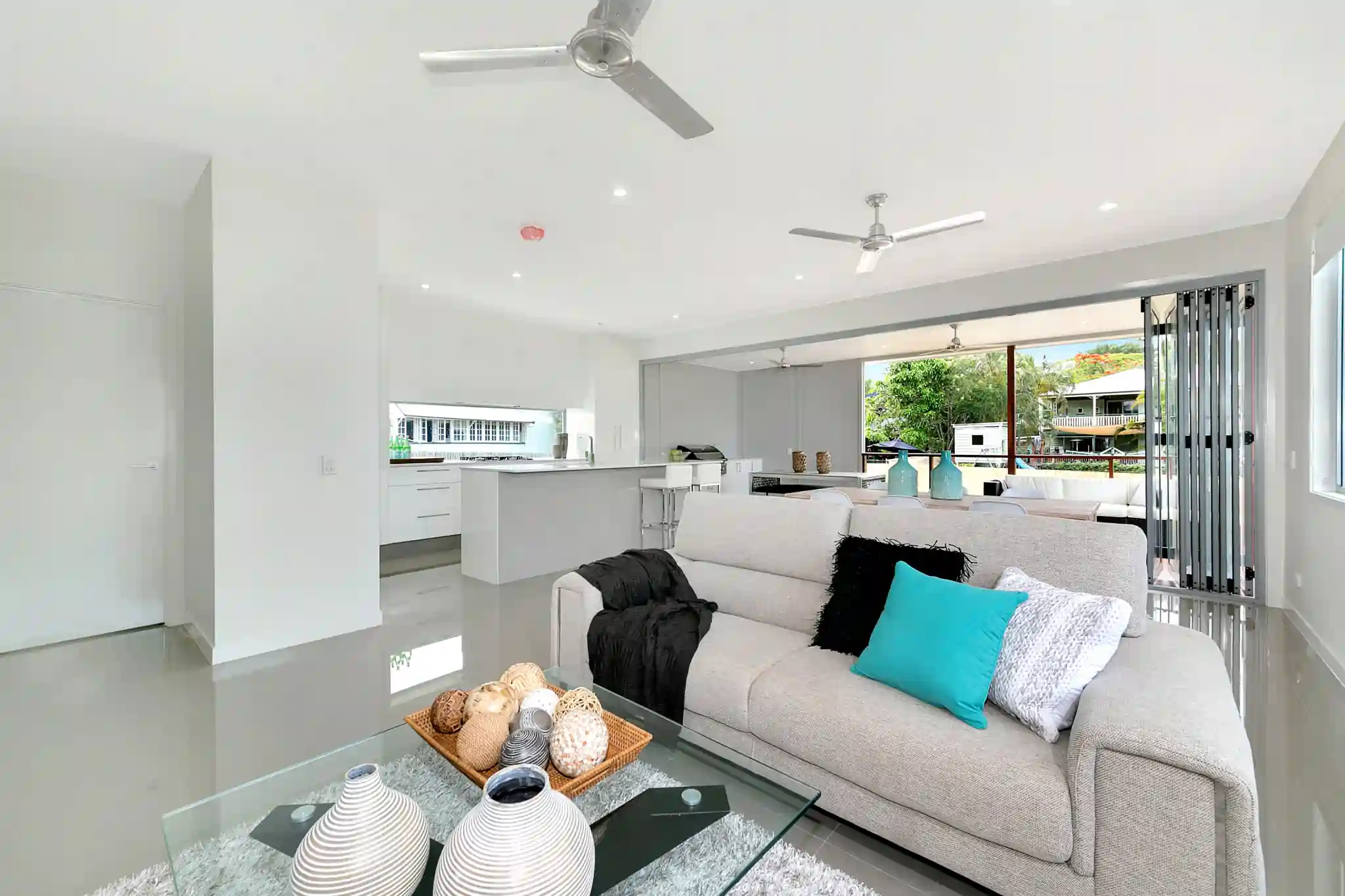Looking at the open living lounge room into the new modern kitchen and deck
