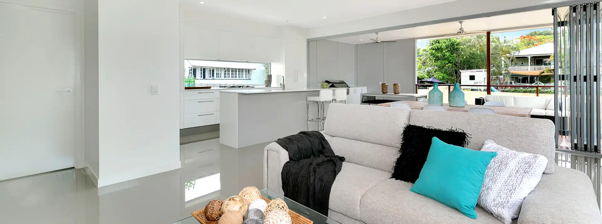 Looking at the open living lounge room into the new modern kitchen and deck